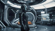 A figure in a sleek, black futuristic suit stands in a high-tech room with glowing panels and metallic surfaces. The helmet fully obscures the face, and the suit features illuminated accents. The background showcases advanced technology, with a modern bed and digital screens. The environment is clean and minimalist, with curved architecture and bright white lighting enhancing the futuristic atmosphere. Ai generated. Photography style.