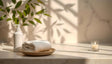 A white soap dispenser and a neatly folded towel rest on a round wooden plate atop a smooth surface. Soft light streams through, casting leaf-shaped shadows from a green plant in the background. A small lit candle in a glass holder adds a warm, peaceful touch. The overall setting is clean and serene, with a natural and soothing ambiance. Ai generated. Photography style.