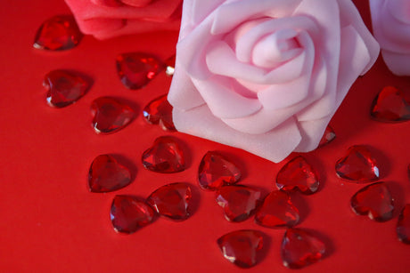 Close-up of delicate roses and scattered heart gems bundle Stock Photos