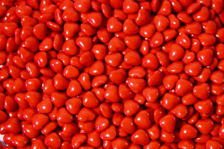 Shiny red heart candies bundle Stock Photos