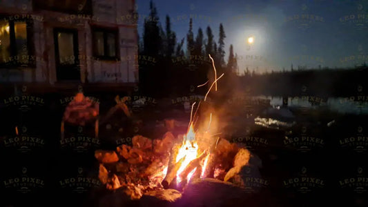 Burning Campfire And The Moon Showing Up In Sky Stock Photos