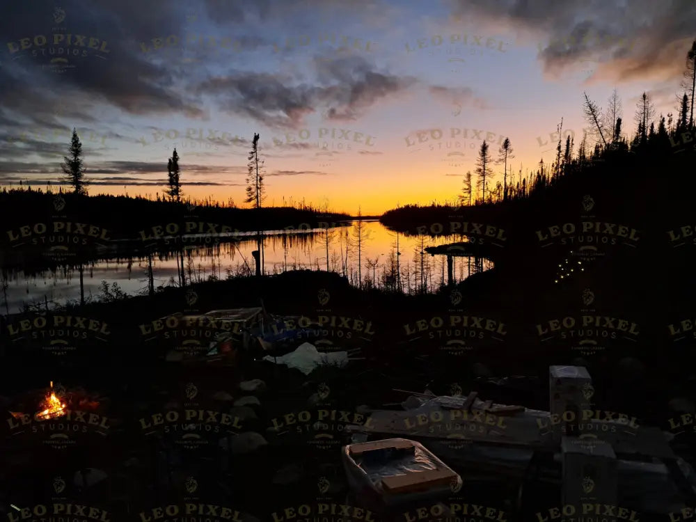 Campfire At Sunset With Cloudy Sky Stock Photos