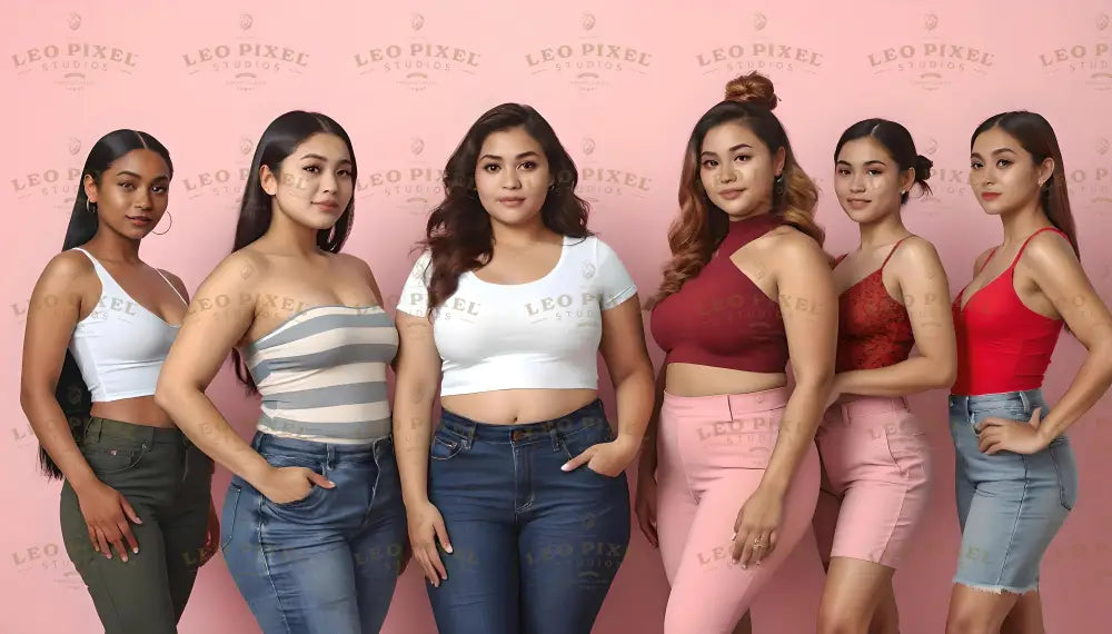 Six women stand confidently in front of a pink background. They wear a variety of tops, including white, striped, and red styles, paired with denim jeans, pink shorts, and green pants. Their hairstyles range from straight and sleek to styled buns. Each woman exudes individuality and elegance, with their poses emphasizing self-assurance and grace. Ai generated. Photography style.