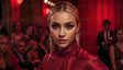 A blonde woman with sharp features and piercing eyes stands out in a red-lit room, wearing a luxurious red satin outfit. Her golden, dangling earrings complement her sleek hairstyle. The background features blurred figures in formal attire, with warm red tones illuminating the space, adding depth and elegance to the scene. Ai generated. Photography style.