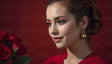 A poised woman gazes softly to the side, her hair styled in a delicate updo. She wears striking gold earrings shaped like orbs that contrast with her smooth complexion. Her lips are painted a soft red, matching her vibrant outfit. The background is a deep red, complementing a bouquet of vivid red roses in the lower left corner, adding depth to the composition. Ai generated. Photography style.