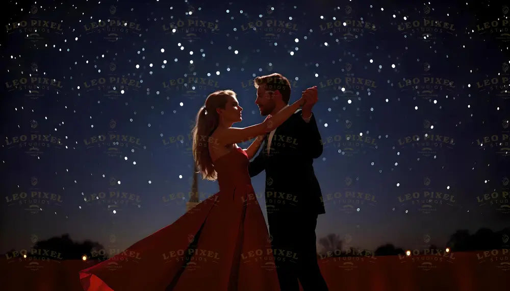 A couple dances gracefully beneath a vast canopy of shimmering stars. The woman’s elegant red gown flows like a wave, its rich hue contrasting against the midnight blue sky. The man, dressed in a sleek black suit, holds her gently as they share a timeless moment. The stars twinkle above, illuminating their silhouettes and casting a romantic glow on the serene evening scene. Ai generated image. Photography style image.