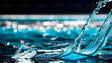 A crystal-clear ice cube rests on the rippling water's surface, reflecting the cool blue tones of the liquid around it. A splash rises beside it, captured in sharp detail as droplets freeze mid-air. The background features soft, out-of-focus bokeh lights, adding depth and contrast. The water's movement, combined with the ice’s smooth surface, creates a dynamic yet serene composition. Ai generated. Photography style.