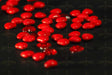 Red hearts on black surface Stock Photos