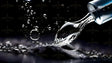 A close-up macro shot of a transparent liquid droplet suspended in motion as it flows from a glass dropper. The droplet is crisp and reflective, with smaller droplets floating in the dark background. The high contrast between the deep black backdrop and the shimmering highlights enhances the clarity of the liquid. The smooth curves of the droplet and its surface tension are sharply defined. Ai generated. Photography style.