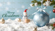 A delicate blue ornament with intricate snowflake designs and a satin ribbon hangs on a frosted evergreen branch. Nestled in snowy surroundings, the scene includes golden baubles, a jolly snowman with a Santa hat, and a cheerful "Merry Christmas" message in elegant green text. The soft focus and starry bokeh backdrop create a magical and serene holiday atmosphere. Ai Generated Image. Photography style.